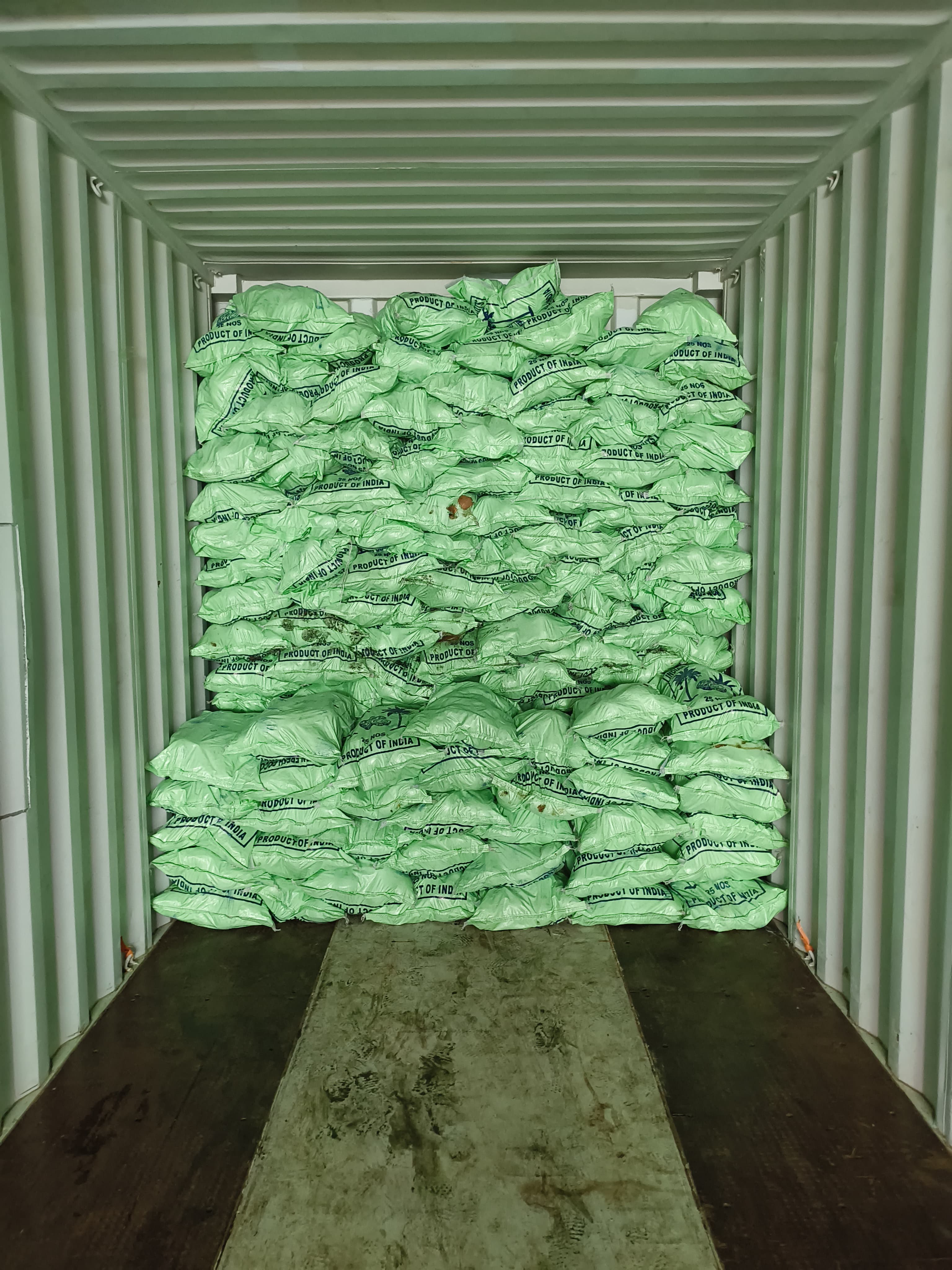 Packed container with green agricultural bags