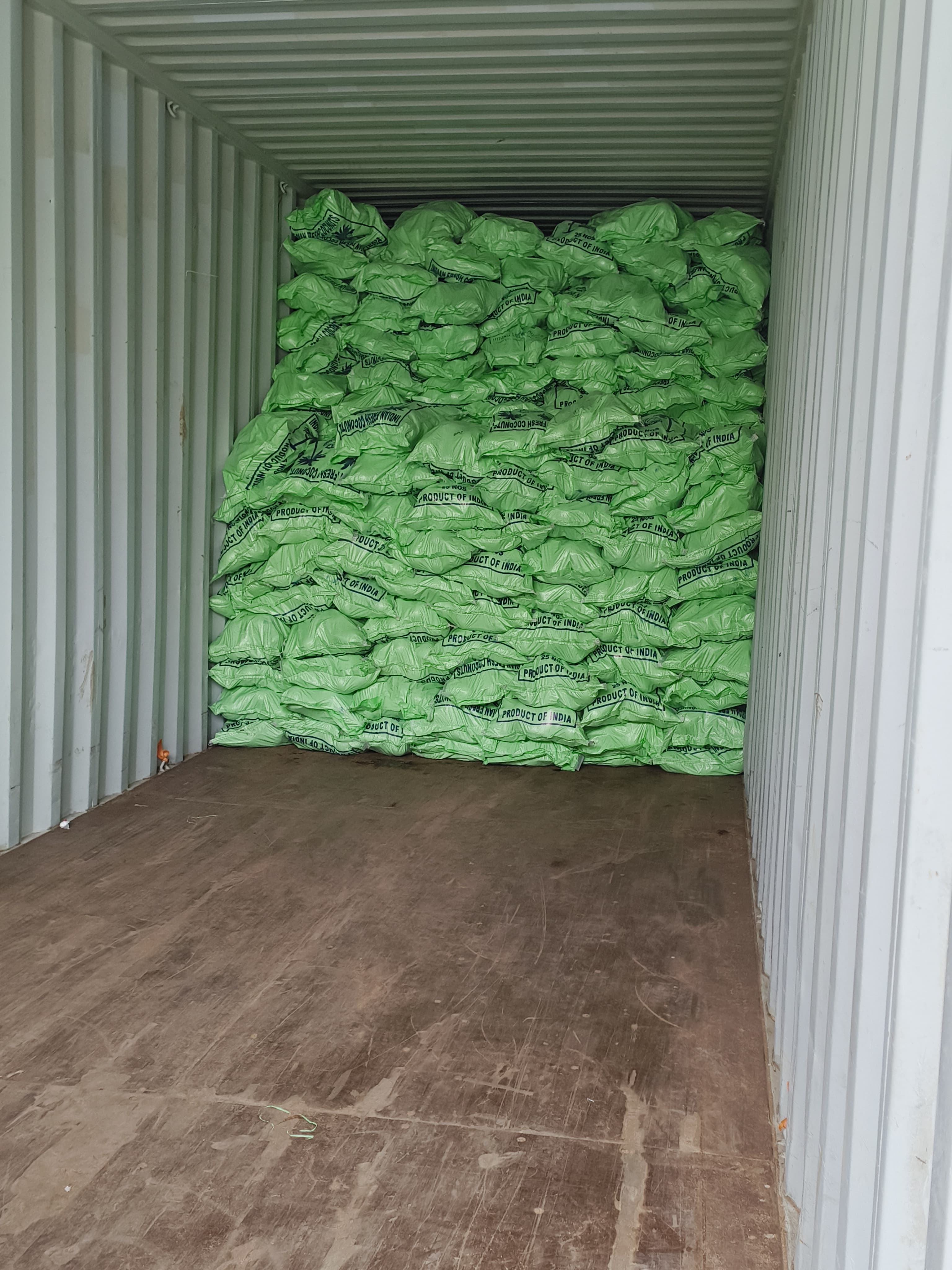 Stacked green produce sacks inside container